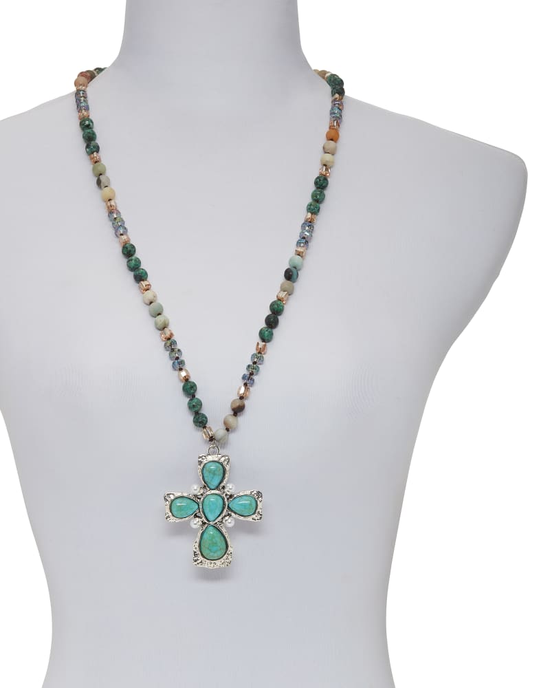 Laying down store cross necklace